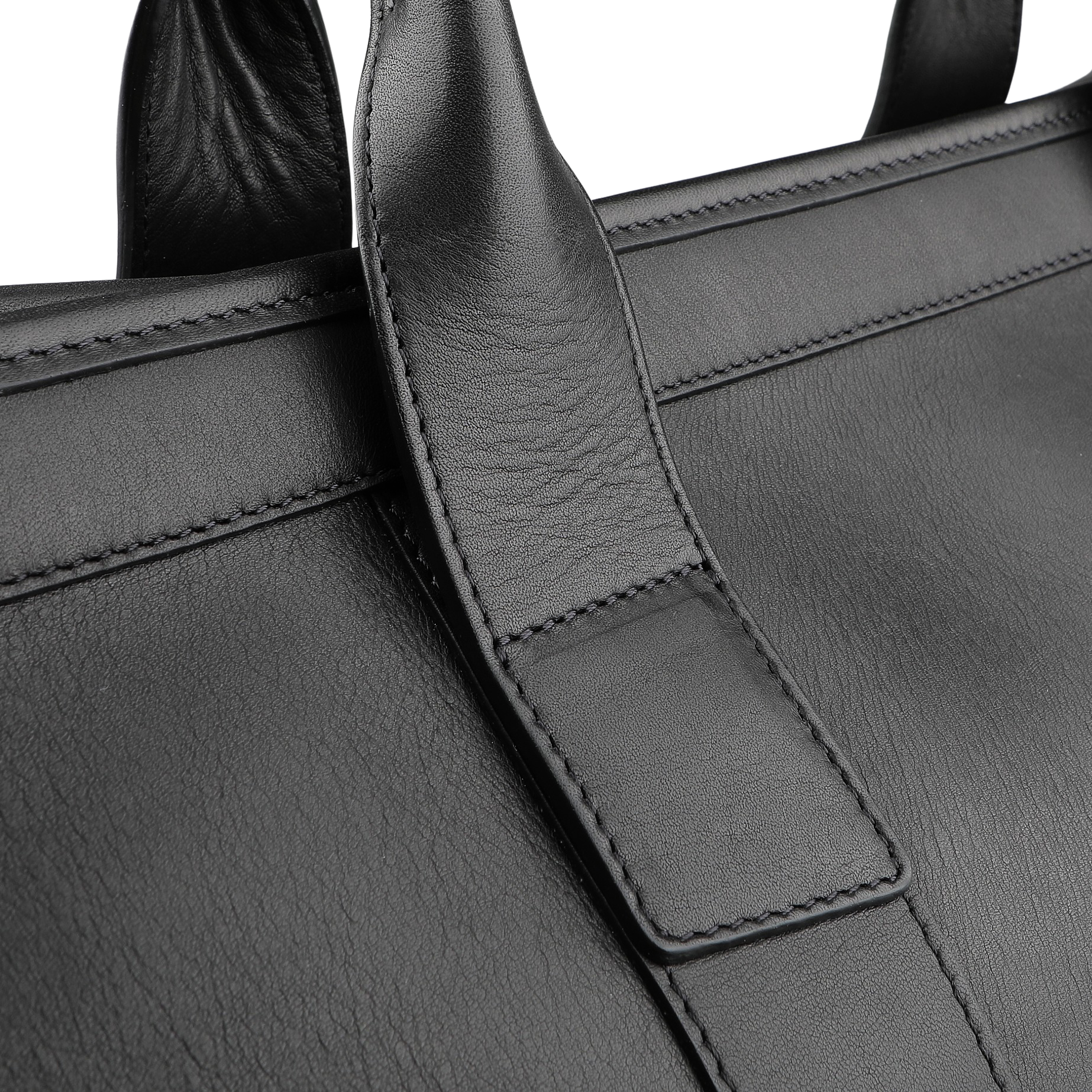 A close-up of Frank Clegg's Black Tumbled Leather Signature Duffle showcases the exquisite strap and intricate stitching details.