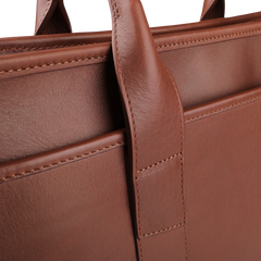 Close-up of the Frank Clegg Chestnut Tumbled Bound Edge Leather Zip Top Briefcase, featuring visible stitching and a sturdy handle loop, designed to fit a 15” laptop.