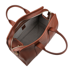 The Chestnut Tumbled Leather Small Travel Duffle by Frank Clegg features a chestnut brown leather exterior, zipper closure, two handles, and a spacious gray interior, ideal as a small travel or weekend bag.