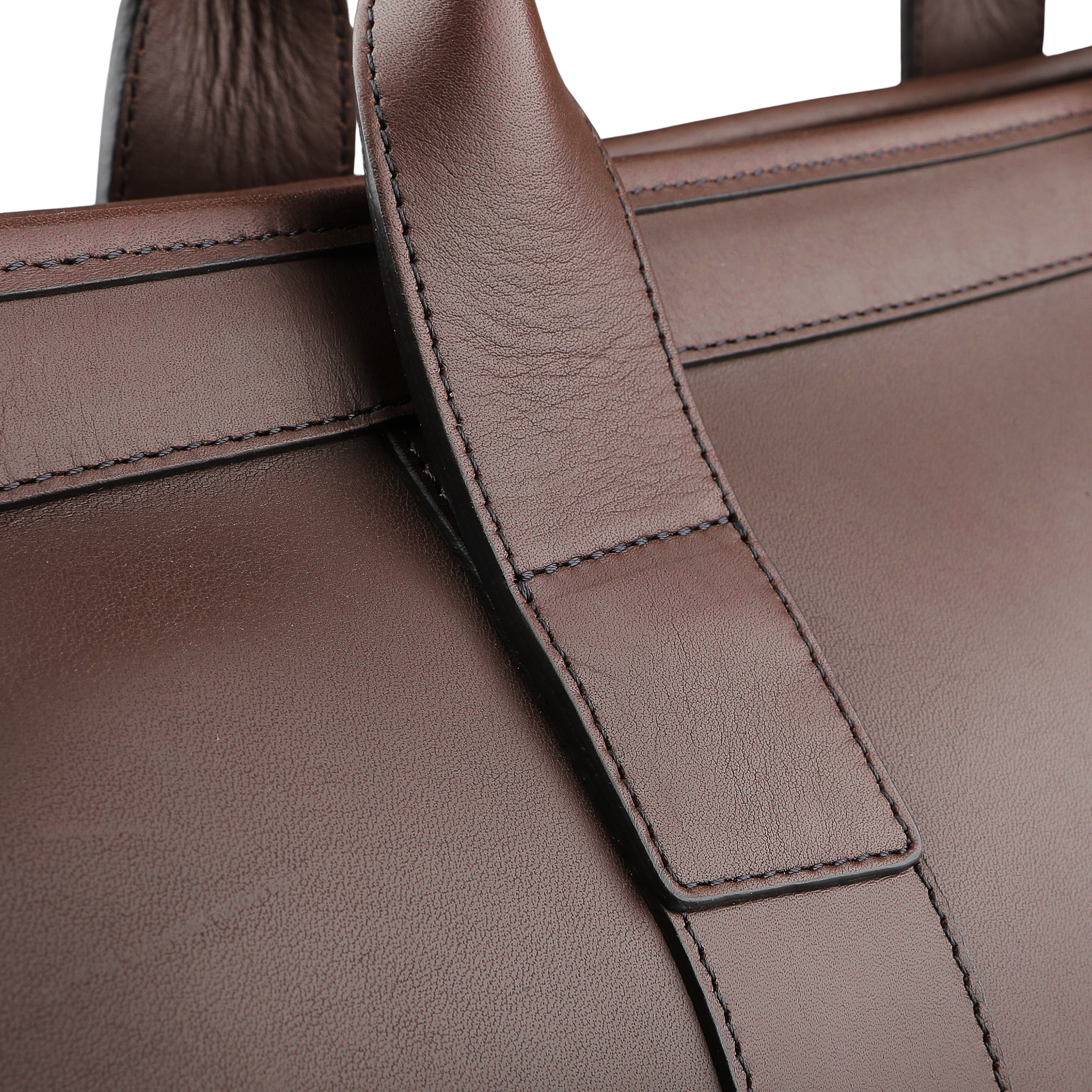 Zoom in on the handle of the Frank Clegg Chocolate Harness Belting Leather Signature Duffle, revealing its brown leather with visible stitching and a smooth texture that highlights its handcrafted quality.