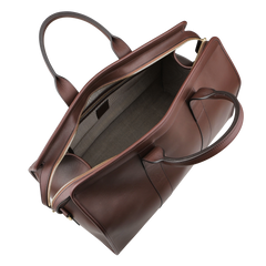 A top view showcases the Frank Clegg Chocolate Harness Belting Leather Signature Duffle handbag, featuring two handles, a zippered compartment, and an empty gray fabric-lined interior.