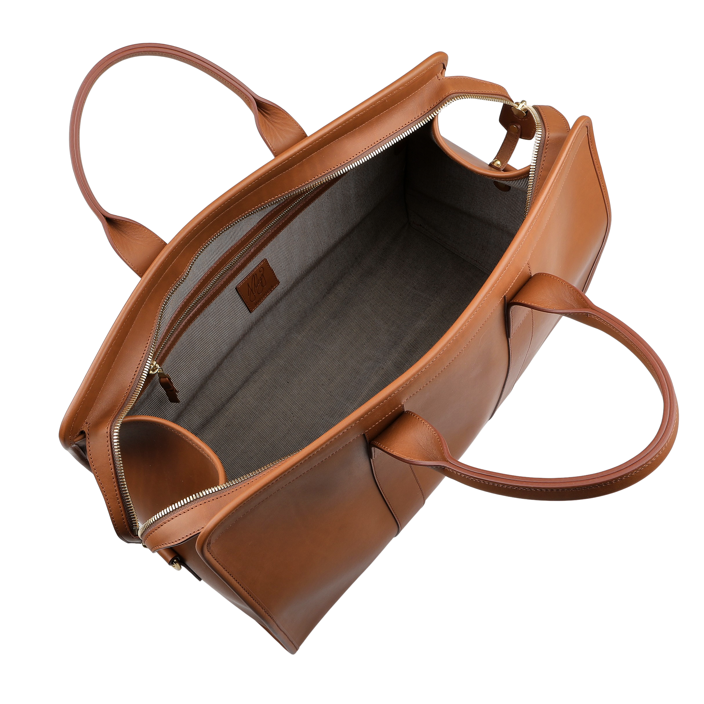 A top-down view of the Cognac Harness Belting Leather Signature Duffle by Frank Clegg shows two handles and a visible gray fabric interior.