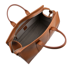 A top-down view of the Cognac Harness Belting Leather Signature Duffle by Frank Clegg shows two handles and a visible gray fabric interior.