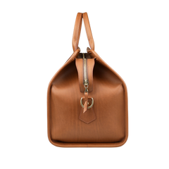 The Cognac Harness Belting Leather Signature Duffle by Frank Clegg features a rich brown leather design with a zipper closure, gold buckle detail, and hand-crafted quality, shown from the side.