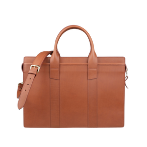 The American-made Cognac Leather Single Gusset Zip Top Briefcase by Frank Clegg is brown with two handles and includes an adjustable shoulder strap.