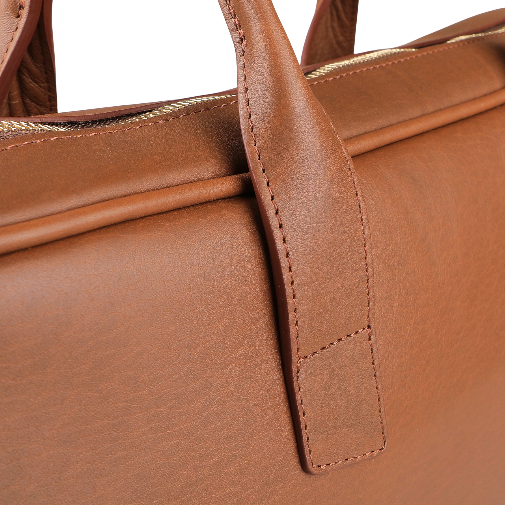 The image showcases the Frank Clegg Cognac Tumbled Leather Computer Briefcase, highlighting its fine stitching and a partially visible zipper. Crafted from tumbled calf leather, it offers a spacious interior designed to fit a 15" laptop.