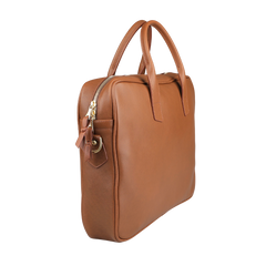 The Cognac Tumbled Leather Computer Briefcase by Frank Clegg is crafted from tumbled calf leather in cognac brown. It features a top handle, zipper closure, accommodates a 15" laptop, and has a distinctive metal ring detail on the side.