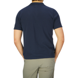 The back view of a man wearing a G.R.P slim fit dark blue cotton linen polo shirt.