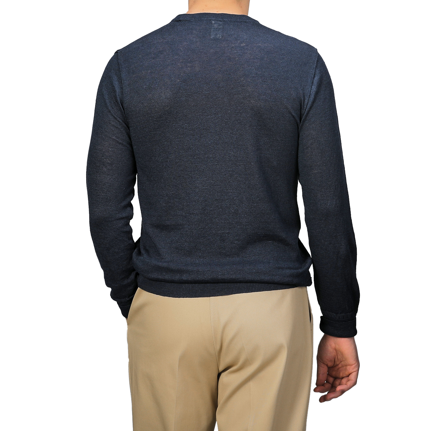 A person wears a Dark Blue Linen Crewneck Sweater by G.R.P and beige pants, facing away.