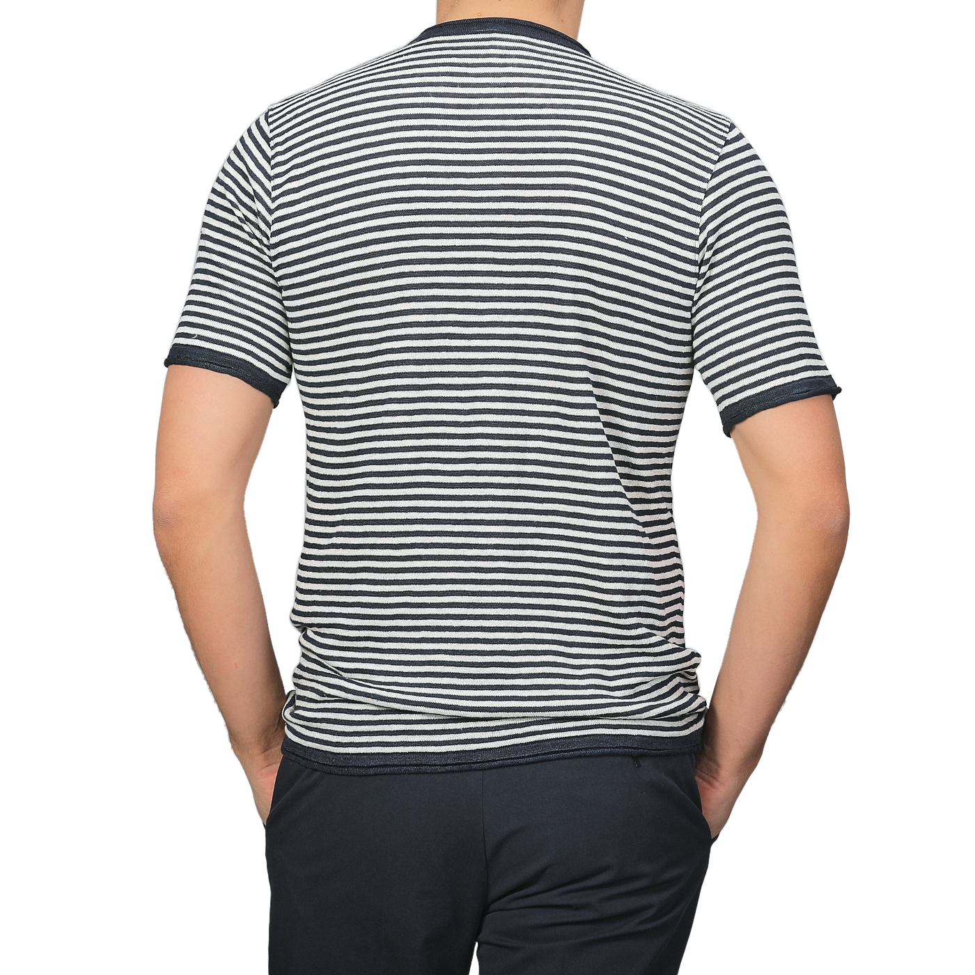 Individual in a Blue Ecru Striped Linen Henley T-Shirt by G.R.P and dark pants, viewed from the back, stands against a plain gray background.