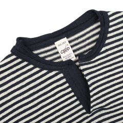 Close-up of a blue ecru striped linen henley t-shirt with a small V-neck, tailored in a slim fit. A tag inside reads "G.R.P".