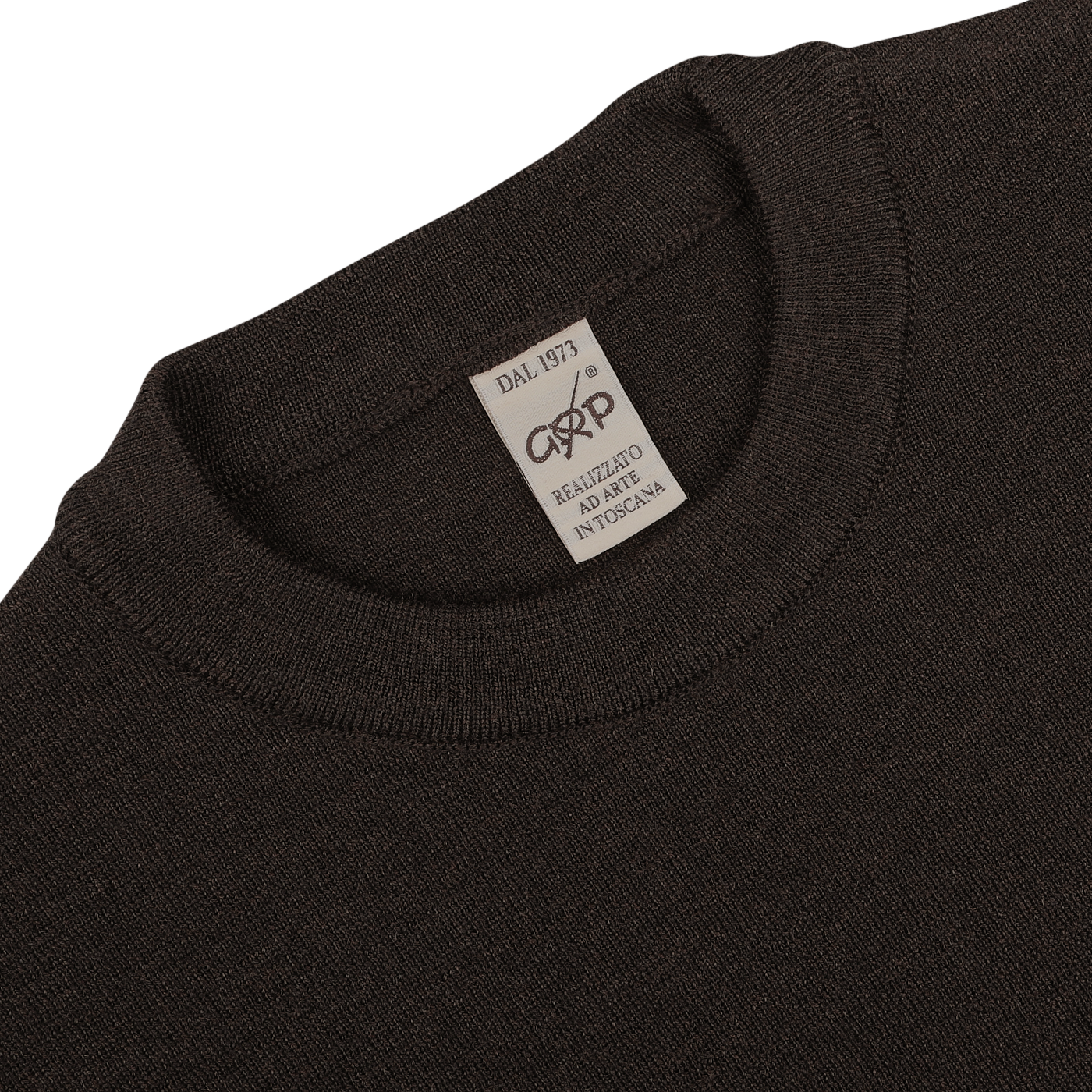 Close-up of a Brown Melange Wool Crewneck Sweater by G.R.P, featuring a white tag that reads "DAL 1973" and "REALIZZATO A MANO IN TOSCANA.