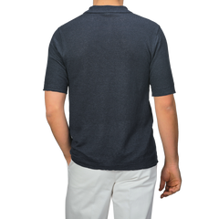 Back view of a person wearing a G.R.P Dark Blue Linen Polo Shirt paired with white pants.