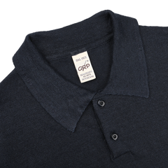 The dark blue slim-fit polo shirt by G.R.P features textured linen fabric, a collar, and three buttons. Label reads "DAL 1973 ASPESI REALIZZATO IN ITALIA.