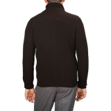 A person is standing with their back to the camera, wearing a black ribbed long-sleeve turtleneck sweater, grey pants, and a Dark Brown Wool Cashmere Zip Jacket by G.R.P.