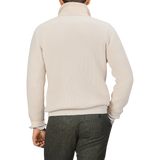 A person wearing a G.R.P Ecru Beige Wool Cashmere Knitted Jacket, paired with dark gray trousers, viewed from the back.