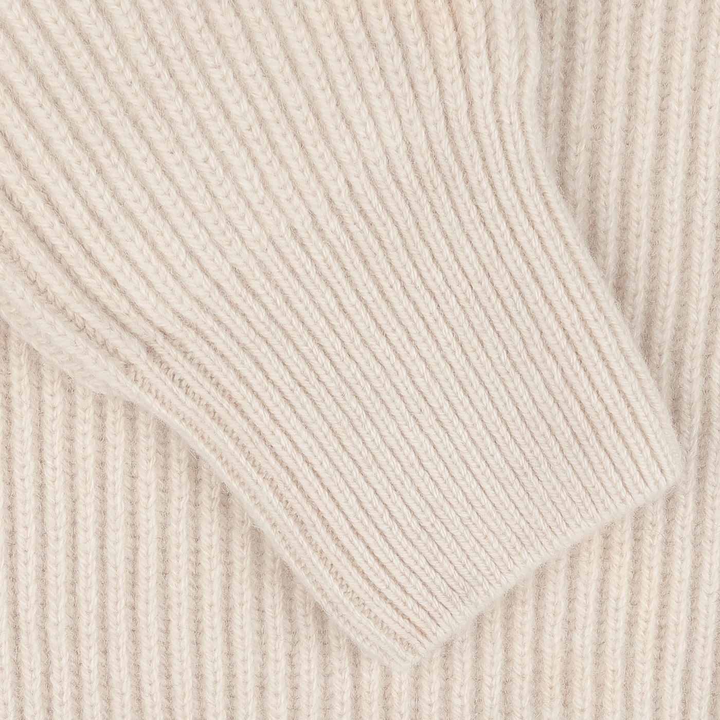 Close-up of the Ecru Beige Wool Cashmere Knitted Jacket sleeve by G.R.P, showcasing the ribbed texture and detailed knitting pattern. The luxurious blend of wool and cashmere adds a touch of elegance to this exquisite piece.