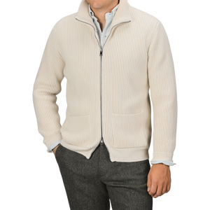 A person is wearing a G.R.P Ecru Beige Wool Cashmere Knitted Jacket over a white collared shirt and dark trousers. The full-zip ribbed cardigan, which features pockets on both sides, obscures the person's face from view.