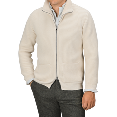 A person is wearing a G.R.P Ecru Beige Wool Cashmere Knitted Jacket over a white collared shirt and dark trousers. The full-zip ribbed cardigan, which features pockets on both sides, obscures the person's face from view.