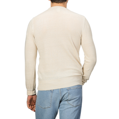 A person is shown from the back against a plain background, wearing a slim fit Ecru Beige Linen Crewneck Sweater by G.R.P and blue jeans.