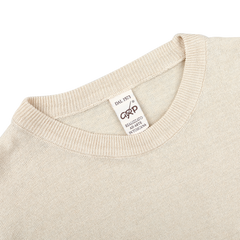 A close-up of an Ecru Beige Linen Crewneck Sweater, designed with a slim fit, features a tag reading "DAL 1973" and "MADE IN ITALY" from the brand G.R.P.