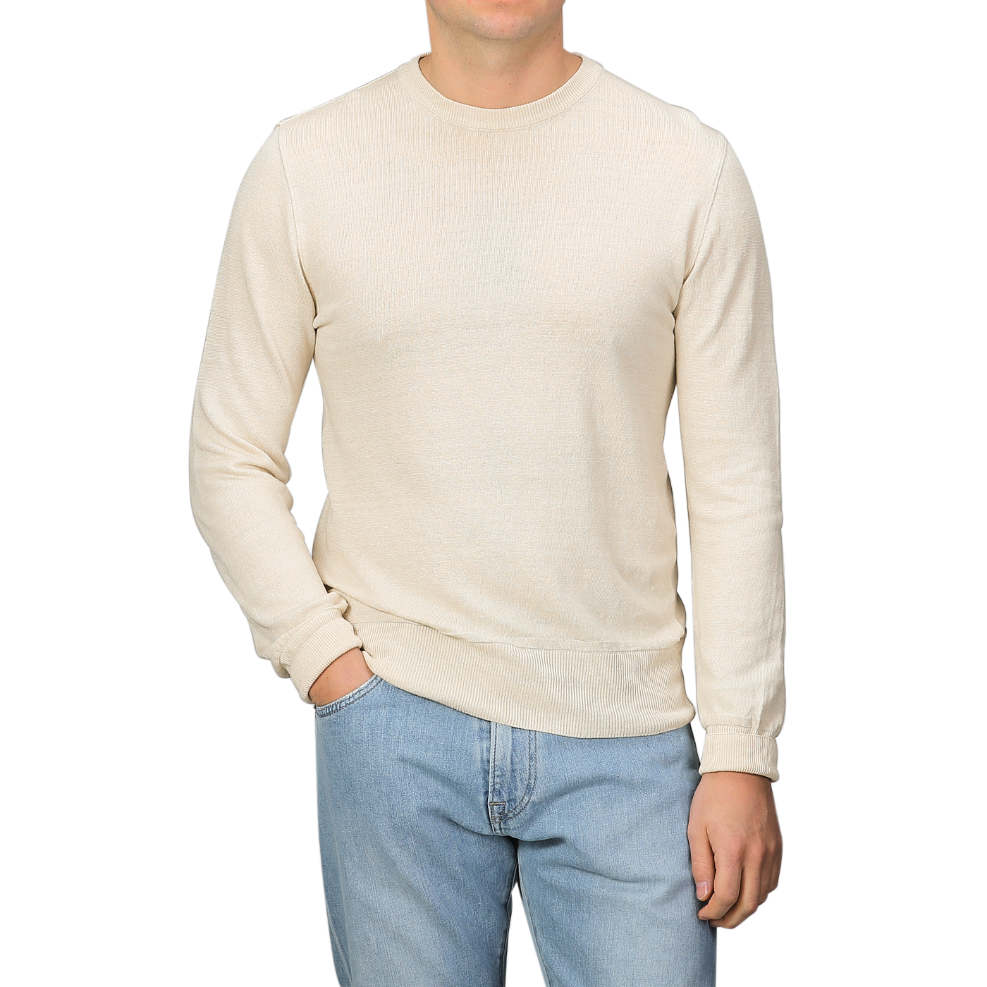 A person wearing a G.R.P Ecru Beige Linen Crewneck Sweater with light blue jeans, standing against a plain background.