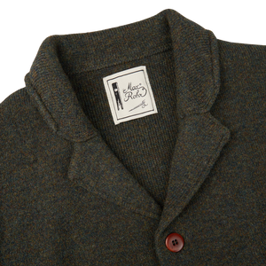 A Green Melange Merino Wool Knitted Jacket with a G.R.P label on it.