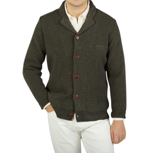 A man wearing a Green Melange Merino Wool Knitted Jacket made by G.R.P.