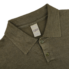 The Military Green Linen Polo Shirt by G.R.P is a slim-fit polo with three buttons, crafted from pure linen, and has a brand label inside the collar.