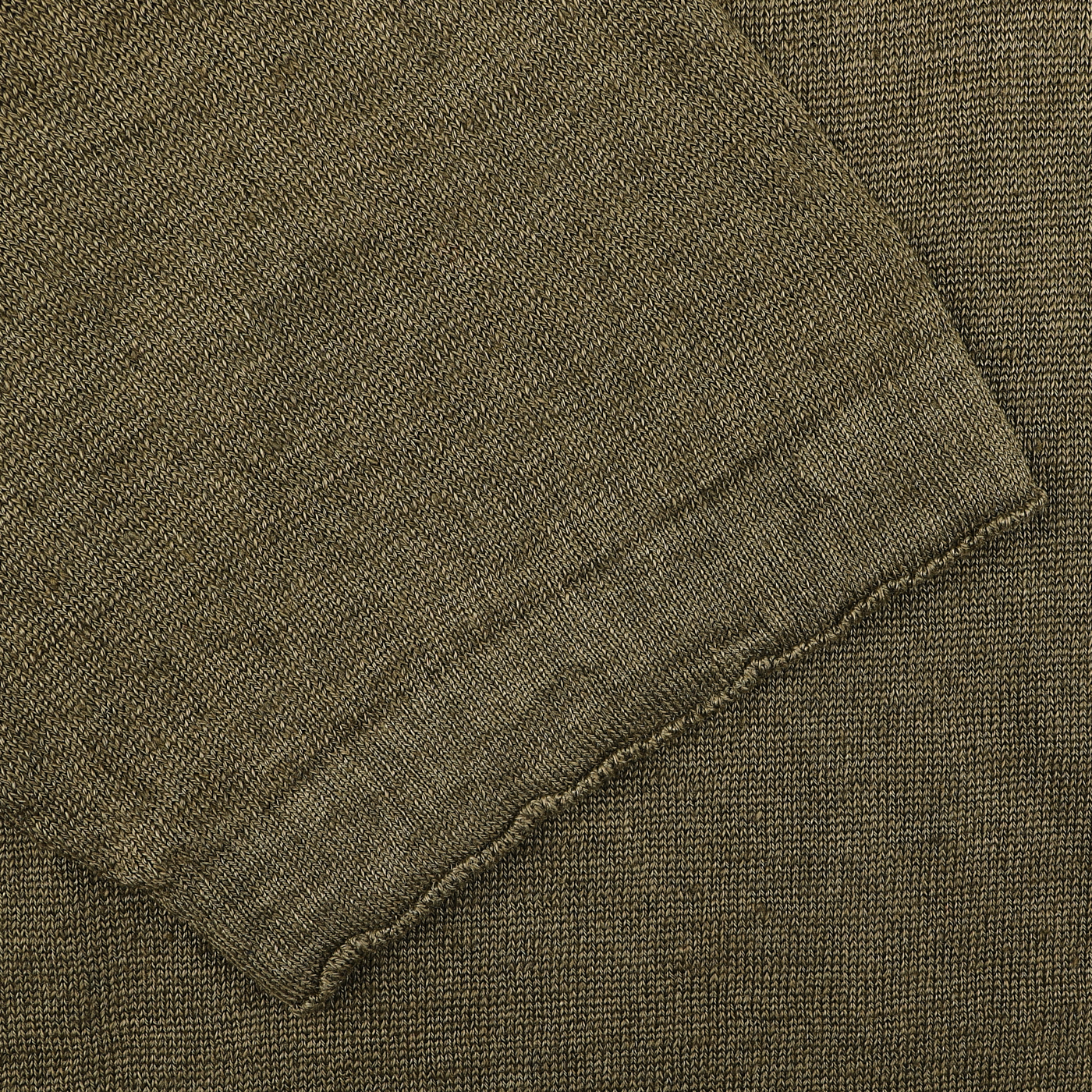 Close-up of the G.R.P Military Green Linen Polo Shirt's textured fabric, featuring a detailed weave pattern and an elegant seam along the edge.