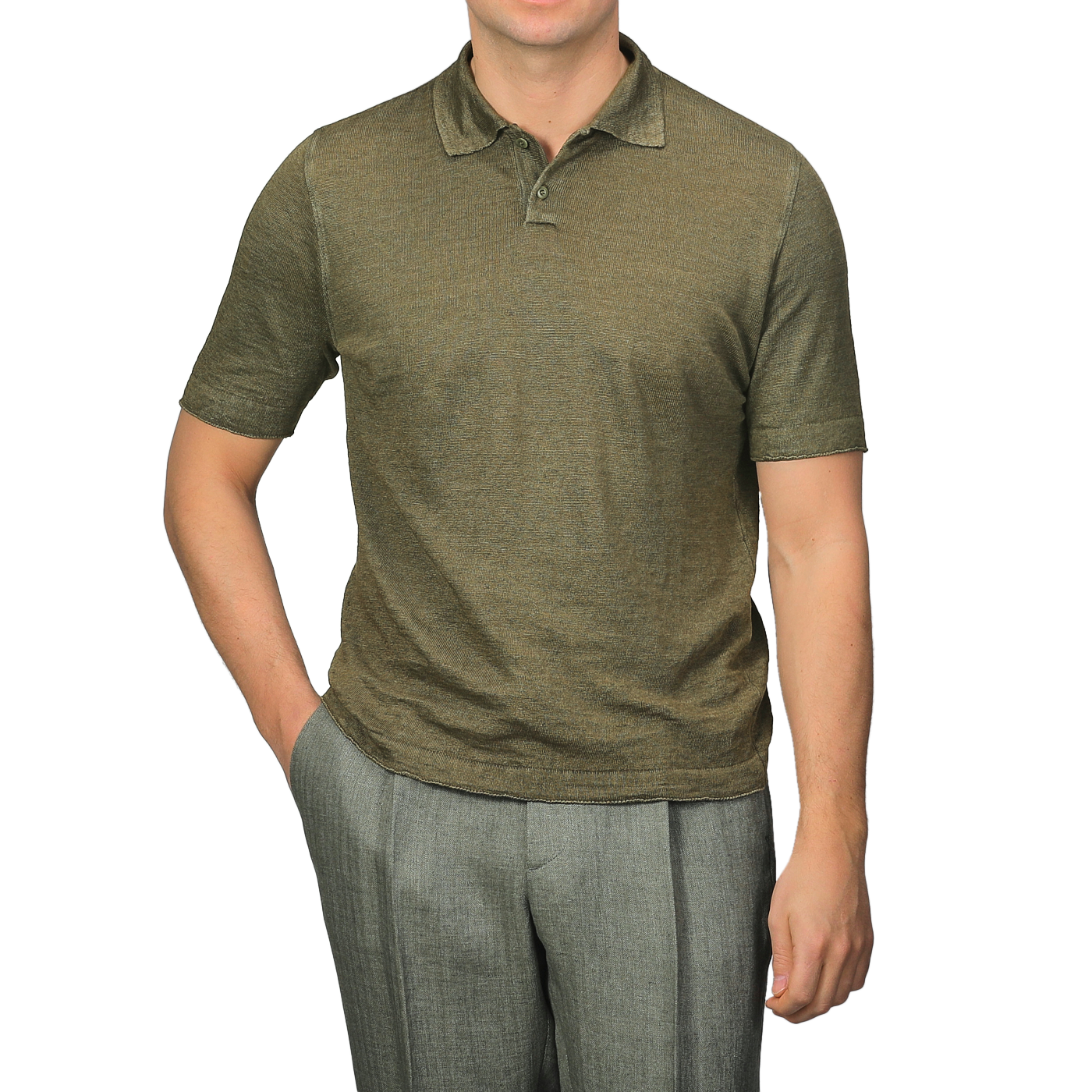 A person in a G.R.P Military Green Linen Polo Shirt and gray slim fit pants stands with one hand in their pocket, their face not visible.