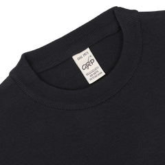 Close-up of the neckline and label of the Night Blue Wool Crewneck Sweater by G.R.P. The label reads "DAL 1973" and indicates it is made in Italy from pure merino wool.