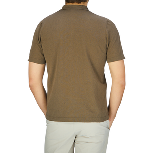 The back view of a man wearing a G.R.P Olive Green Cotton Linen Polo Shirt.
