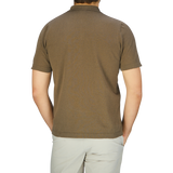 The back view of a man wearing a G.R.P Olive Green Cotton Linen Polo Shirt.