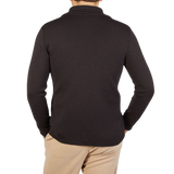 The back view of a man wearing a G.R.P Brown Melange Merino Wool Zip Jacket and tan pants.