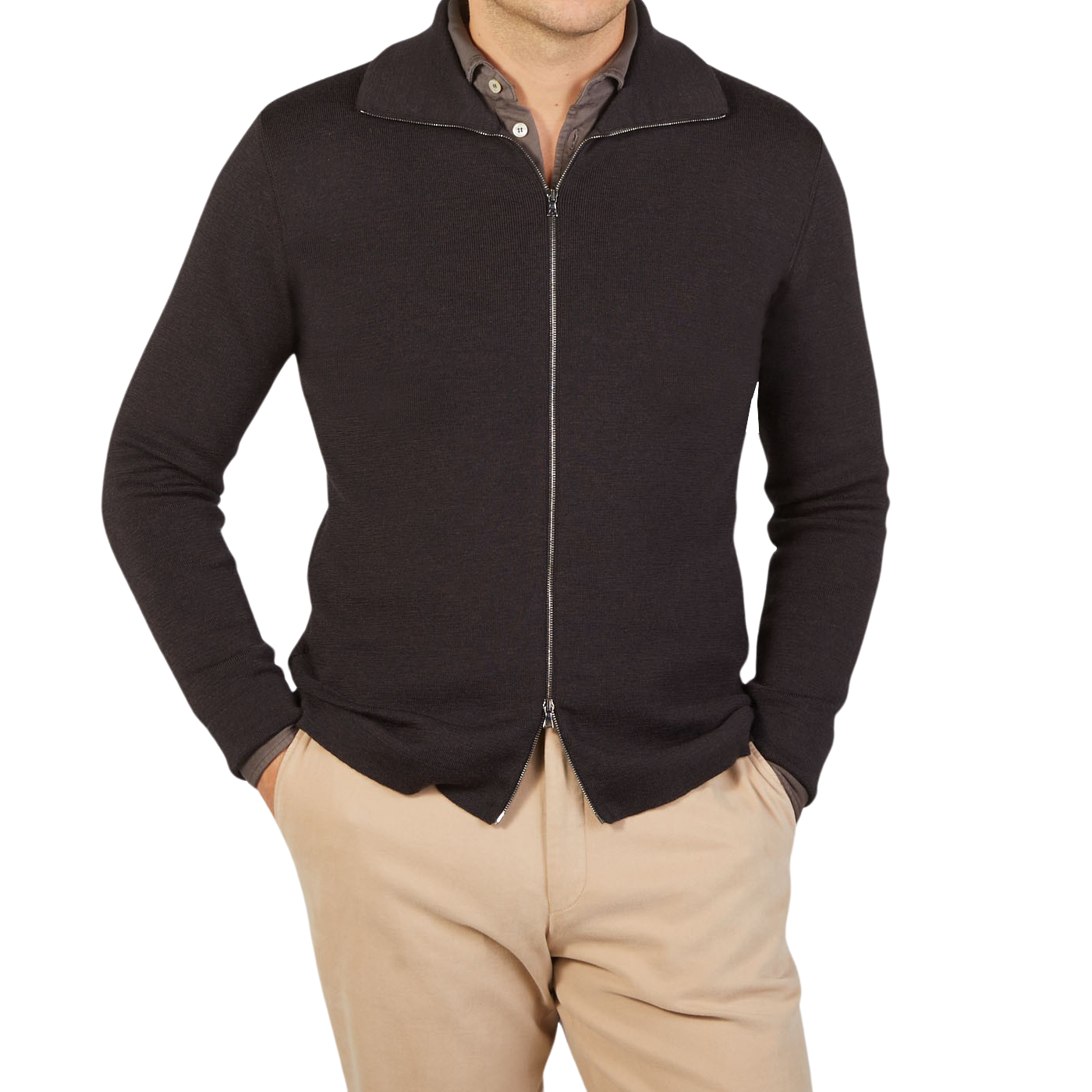 A man wearing a G.R.P brown melange merino wool zip jacket and tan pants.