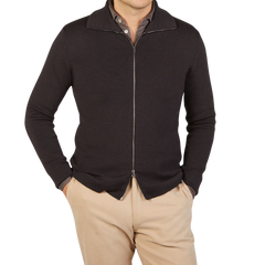 A man wearing a G.R.P brown melange merino wool zip jacket and tan pants.