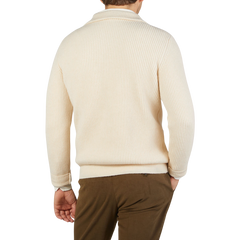 The back view of a man wearing the G.R.P Ecru Wool Cashmere Anorak Sweater and khaki pants.