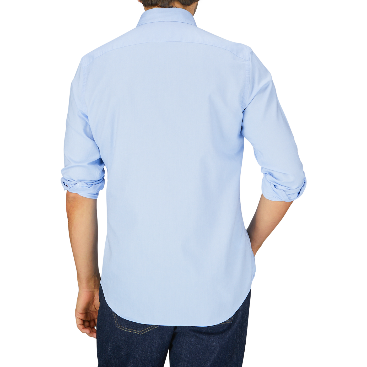 Man seen from behind wearing a Glanshirt light blue pure cotton oxford shirt with mother-of-pearl buttons and dark blue jeans.