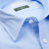 Close-up of a light blue Glanshirt pure cotton dress shirt with a "slowear" label.