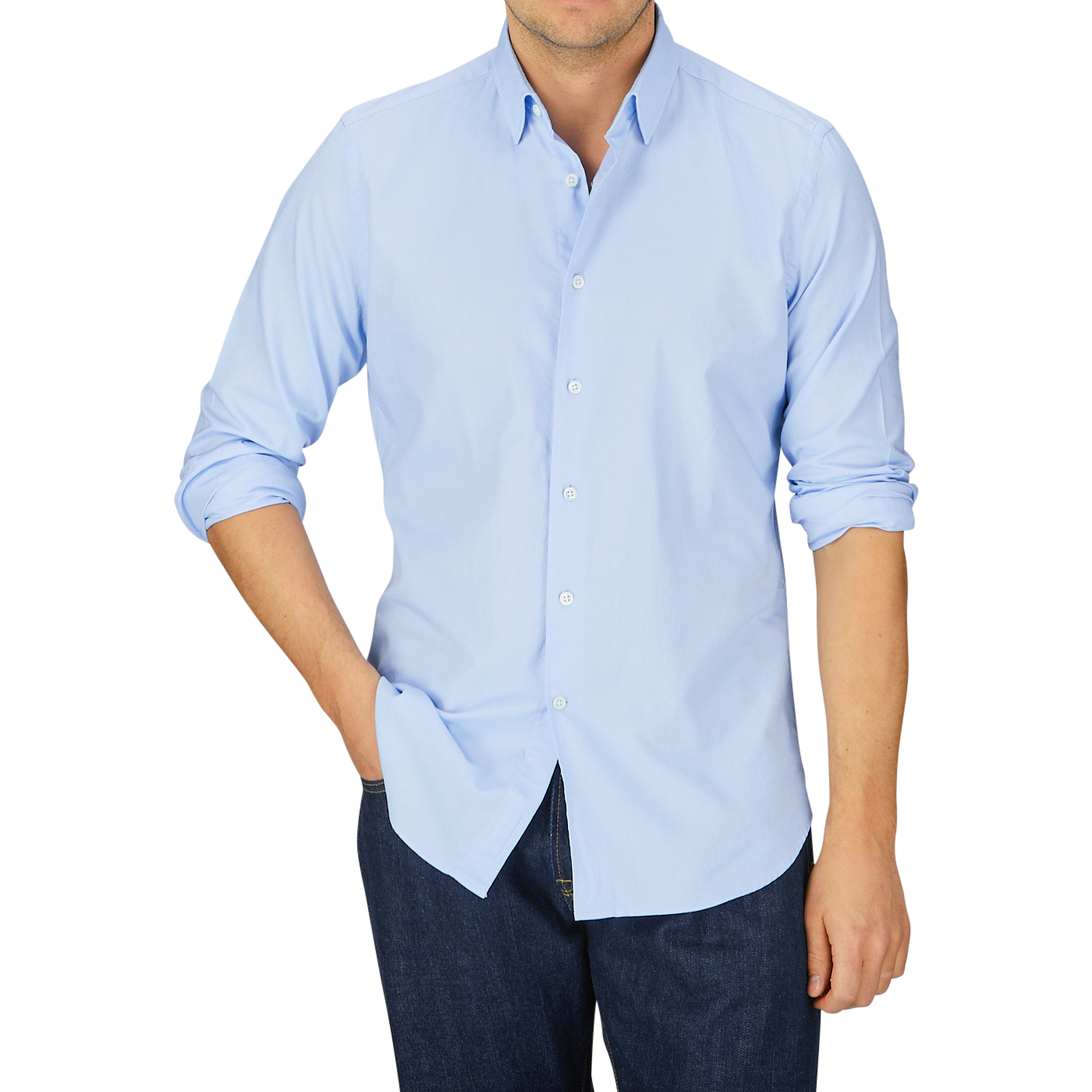 Man wearing a Glanshirt Light Blue Cotton Oxford Regular Shirt with mother-of-pearl buttons and jeans against a grey background.