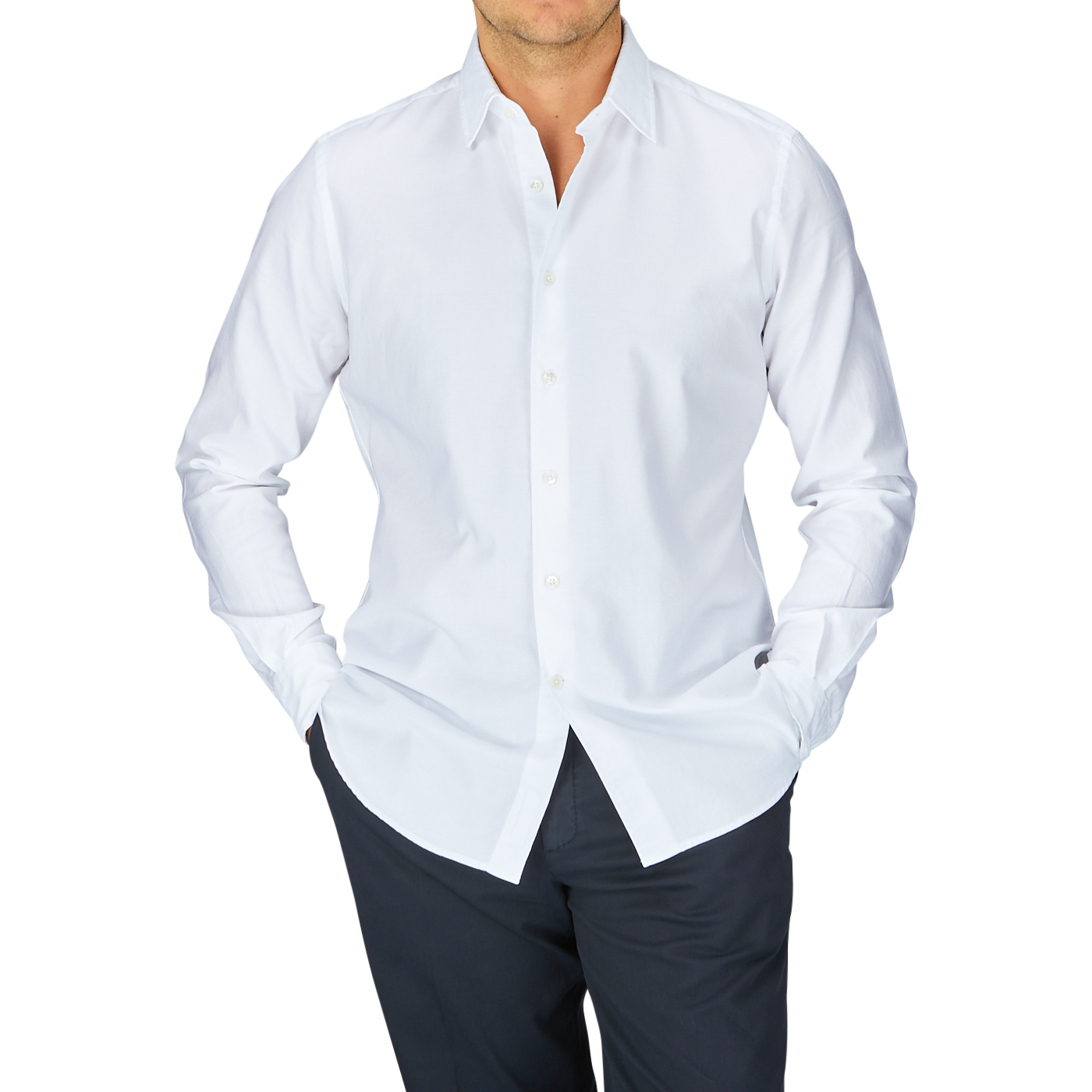 Man wearing a Glanshirt White Cotton Oxford Regular Shirt with mother-of-pearl buttons and dark trousers.