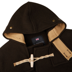 A dark brown Gloverall Wool Monty Duffle Coat with a hood.