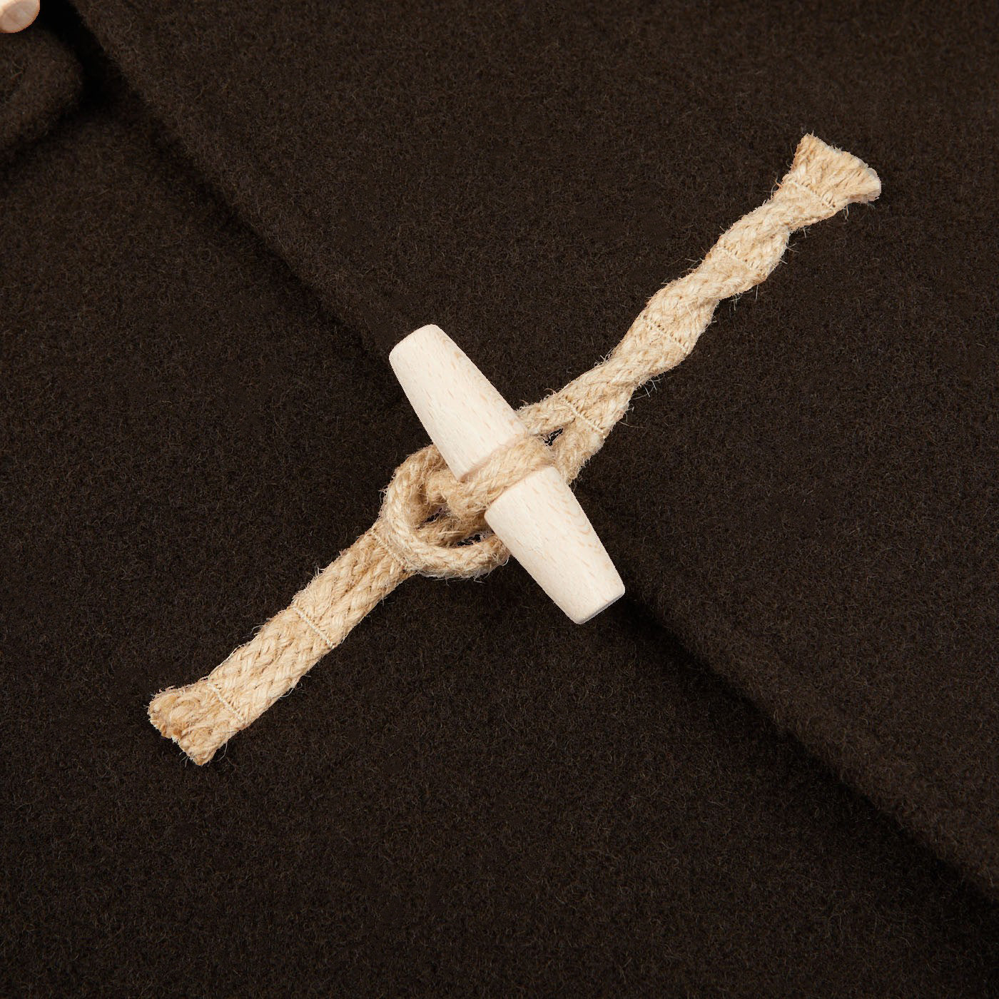 A close up of a dark brown Gloverall Monty Duffle Coat.