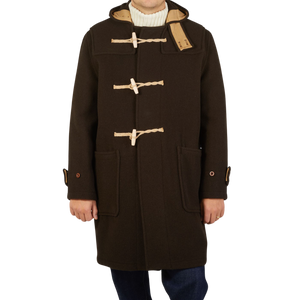 A man wearing a Gloverall Dark Brown Wool Monty Duffle Coat.