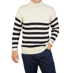 A man wearing a Gloverall Ecru Blue Striped Wool Rollneck sweater.