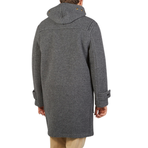 The back view of a man in a Gloverall Grey Melange Wool Monty Duffle Coat.