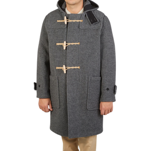 A young explorer sporting a Gloverall Grey Melange Wool Monty Duffle Coat.
