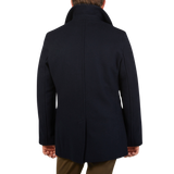 A man wearing a Navy Wool Churchill Peacoat made by Gloverall.