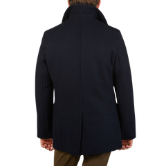 A man wearing a Navy Wool Churchill Peacoat made by Gloverall.